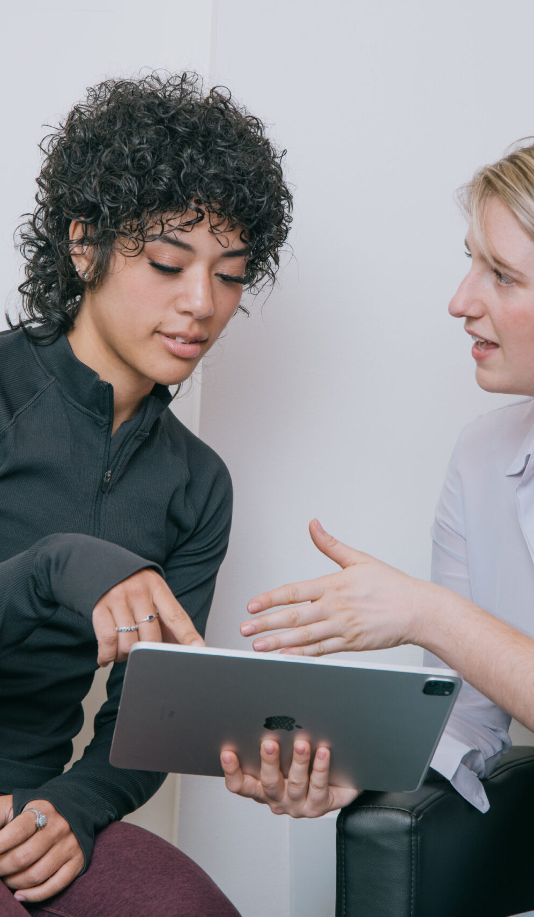 Dr. Wood discussing treatment for concussion and TBI recovery with a patient in her office.